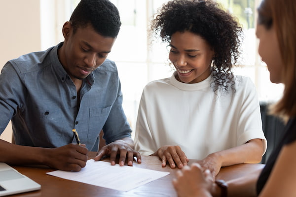 couple signing loan documents